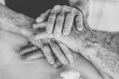 High angle view of people stacking hands