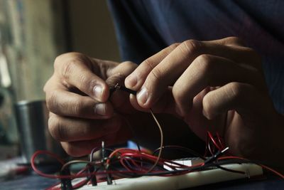 Close-up of man working with electronics