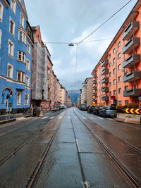 Street amidst buildings against sky