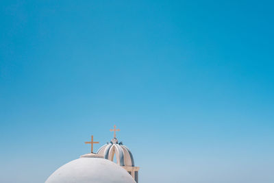 Low angle view of church roof against clear blue sky