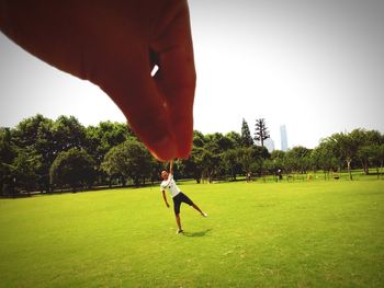 Low section of man playing soccer in park