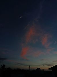 Low angle view of silhouette building against sky at night