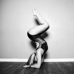  woman dancing on the hardwood floor against the white wall