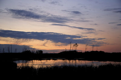 Scenic view of lake against romantic sky at sunset