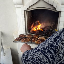 Low section of woman holding fire at home