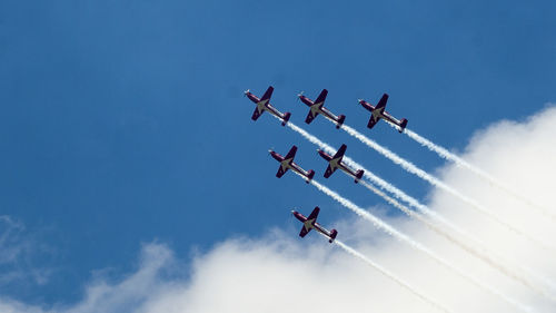 Low angle view of airplane flying against sky