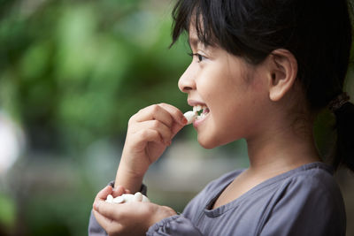 Close-up of young woman blowing bubbles