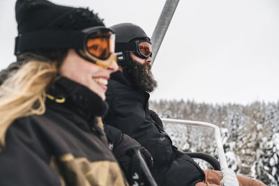 Italy, modena, cimone, couple in a ski lift