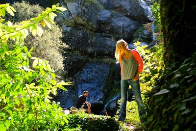 Full length of woman standing in forest