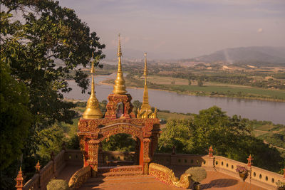 Temple by building against sky