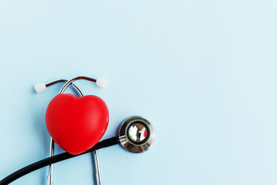 Low angle view of red heart shape against white background