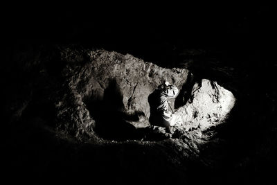 High angle view of man sitting on rock