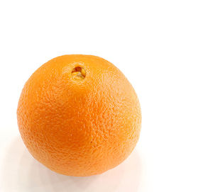 Close-up of orange apple against white background