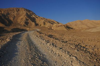 Scenic view of mountains against clear blue sky