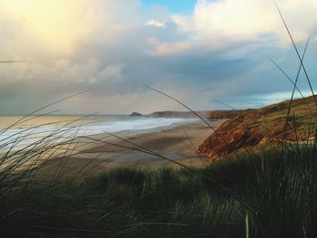 Scenic view of sea against cloudy sky