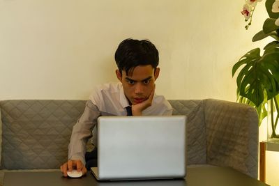 Young man using laptop at home