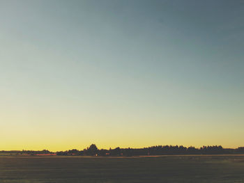 Scenic view of sea against clear sky during sunset