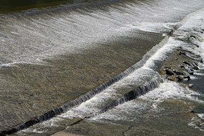 High angle view of water flowing from dam