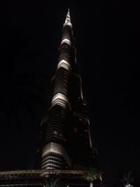 Low angle view of tower against sky at night