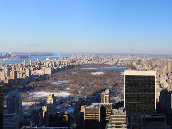 High angle view of city buildings against clear sky