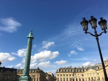 Low angle view of skyscrapers against blue sky