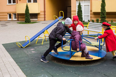 Kids playing on merry go round outdoors