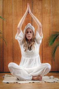 Woman practicing kundalini yoga, kriya exercises for the navel center and bowel waste elimination