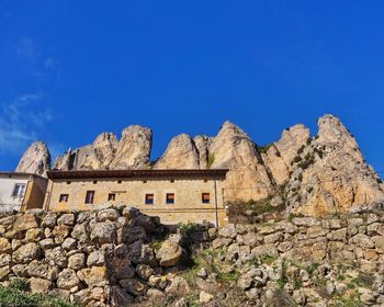 Low angle view of old building against blue sky