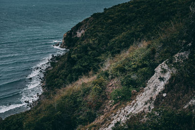 High angle view of sea by cliff