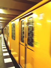 Blurred motion of train at railroad station
