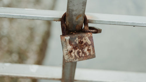 Close-up of padlocks on metal railing