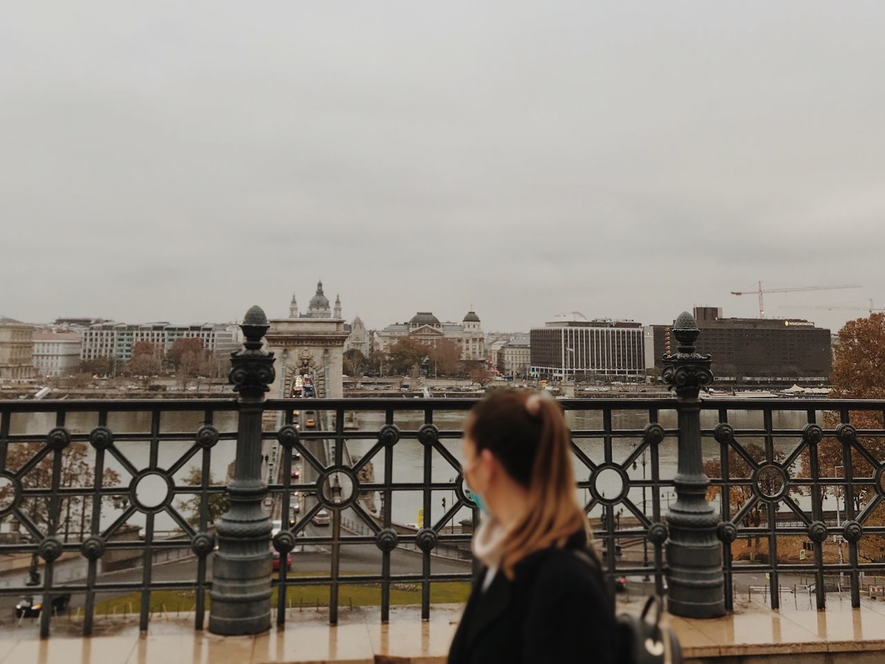 WOMAN LOOKING AT CITYSCAPE