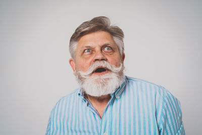 Portrait of man standing against white background