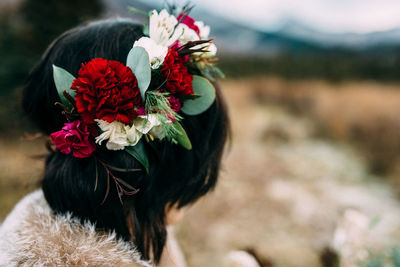 Side view of woman wearing flowers