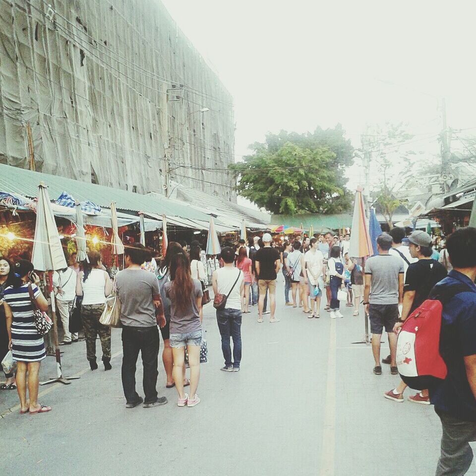 large group of people, person, men, walking, lifestyles, architecture, built structure, street, leisure activity, building exterior, mixed age range, city life, city, crowd, day, casual clothing, outdoors, market, standing