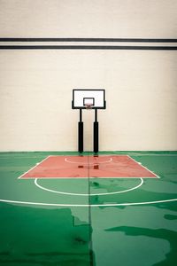 Wet basketball court against wall