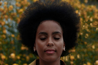 Close-up portrait of young woman with eyes closed