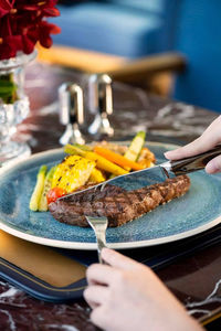 Cropped hand of woman having food