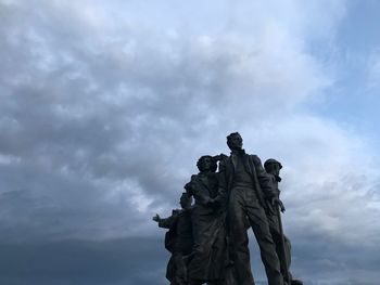 Low angle view of statue against cloudy sky