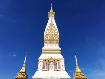 Low angle view of statue of temple against blue sky