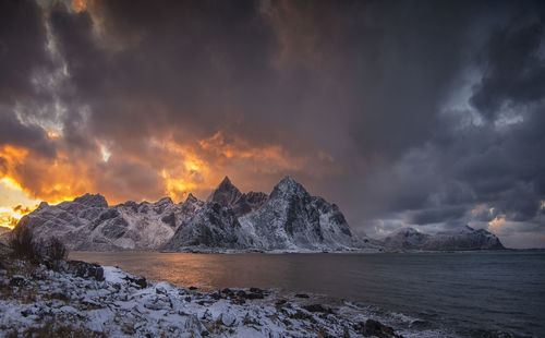 Scenic view of snowcapped mountains against sky during sunset