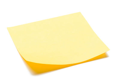 Close-up of yellow paper against white background