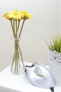 Close-up of white flowers in vase on table