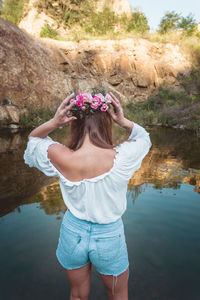 Full length of woman standing by pink flower