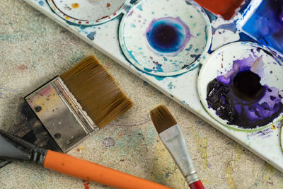 Close-up of paintbrushes and palette on table