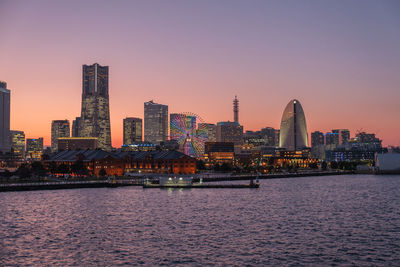 Port on sunset with high buildings.