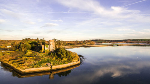 Panoramic view of castle by river against sky