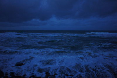 Scenic view of sea against cloudy sky