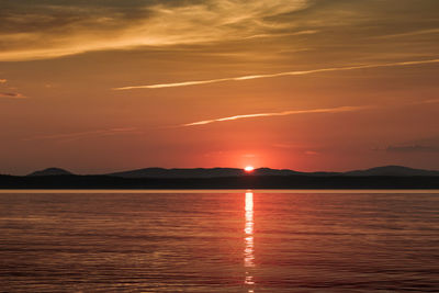 Scenic view of sea against romantic sky at sunset