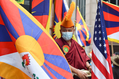 Tibetian monk is posing for a photo during the 37th annual nyc immigrants parade